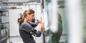 A marine science student writing on a whiteboard
